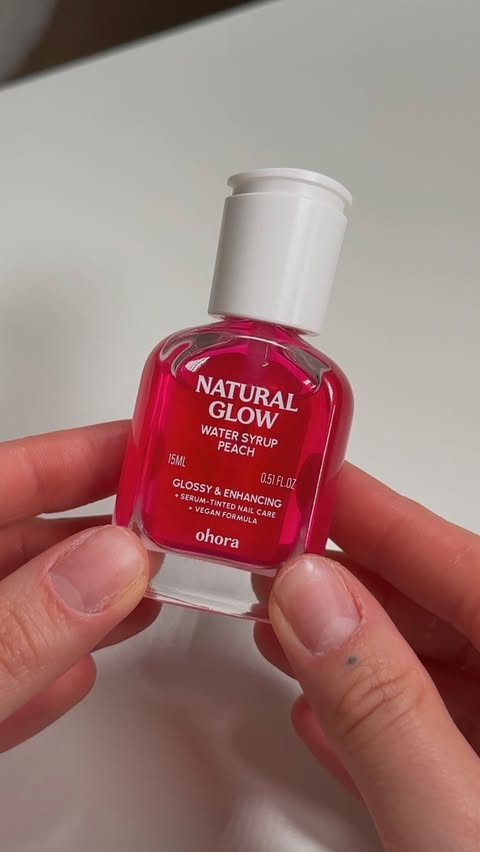 Instagram post by @angelacbeauty for ohora. Caption reads: [...] the Natural Glow Nail Strengthener from....