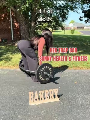 TikTok post by @toddynachelle for Sunny Health & Fitness. Caption reads: [...] loading up my Hex Trap Bar from Sunny Health....