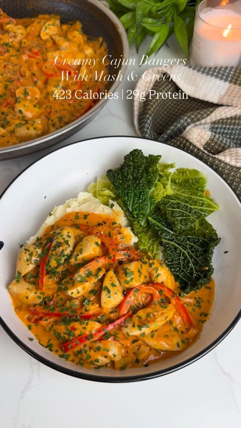 Instagram post by @slimming.gym.and.gin for MyFitnessPal. Caption reads: Recipe in caption ⬇️ Creamy Cajun Bangers & Mash....