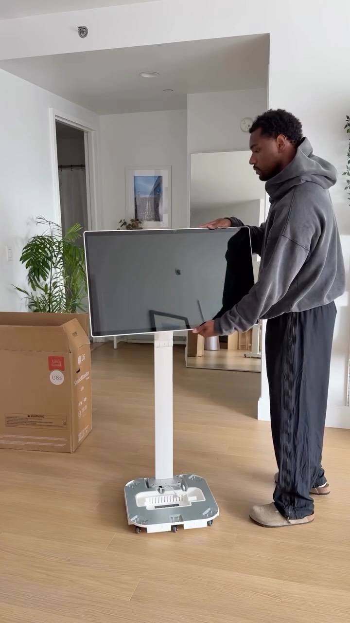 Instagram post by @gyasilinje for LG USA. Caption reads: Unboxing the most futuristic monitor I’ve ever....
