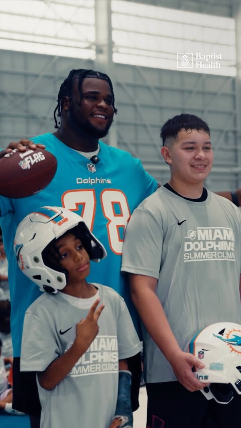 Instagram post by @playfootball for Baptist Health. Caption reads: The Fins Fam take the field 🐬🏈 Looking back at....