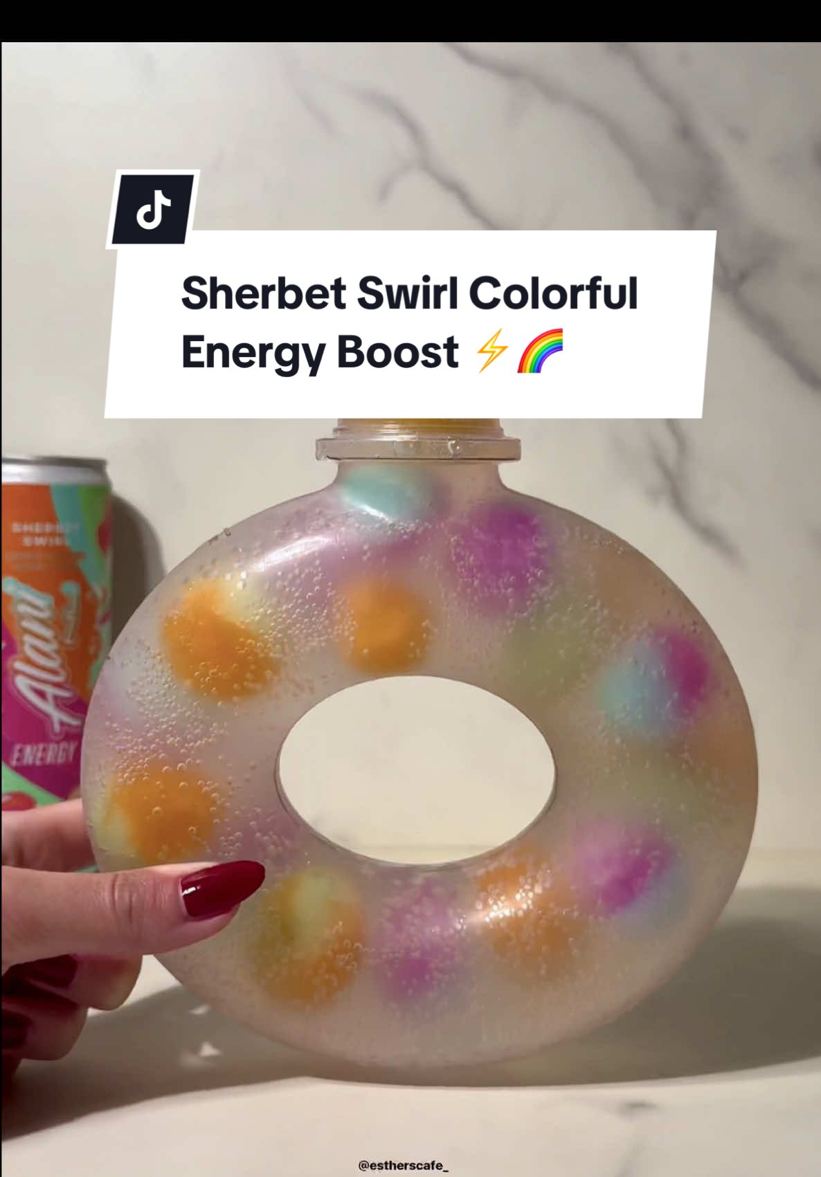 TikTok post by @estherscafe for Alani Nutrition. Caption reads: @Alani Nutrition sherbet swirl colorful energy....