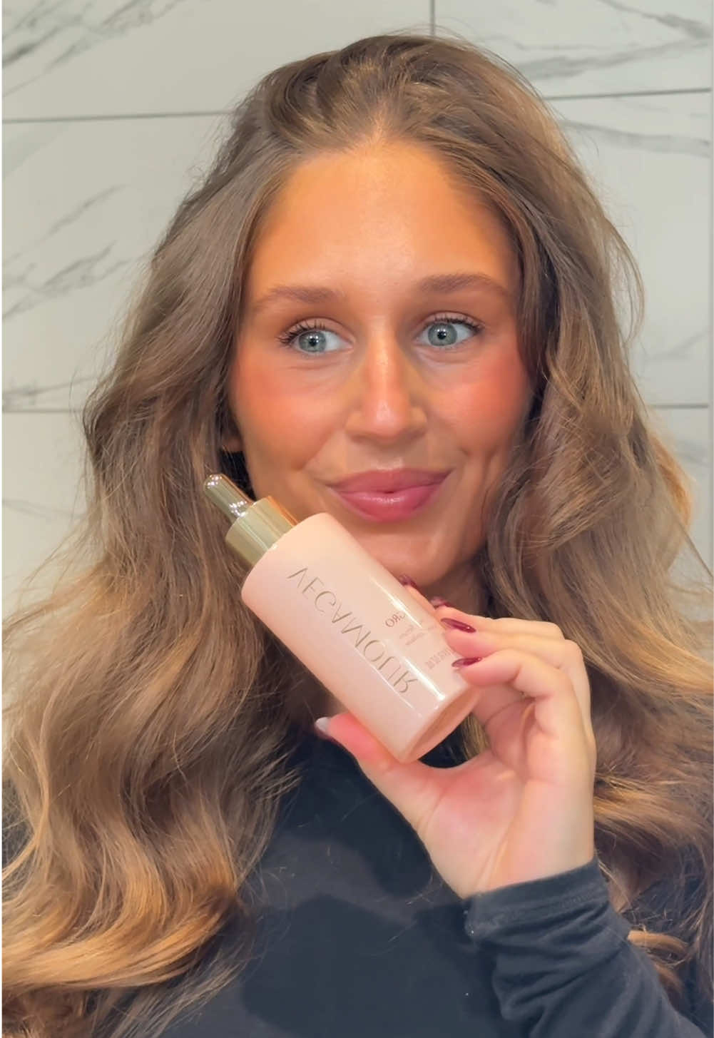 TikTok post by @by.emmaleah for VEGAMOUR. Caption reads: [...] a daily hair serum like the @VEGAMOUR GRO....