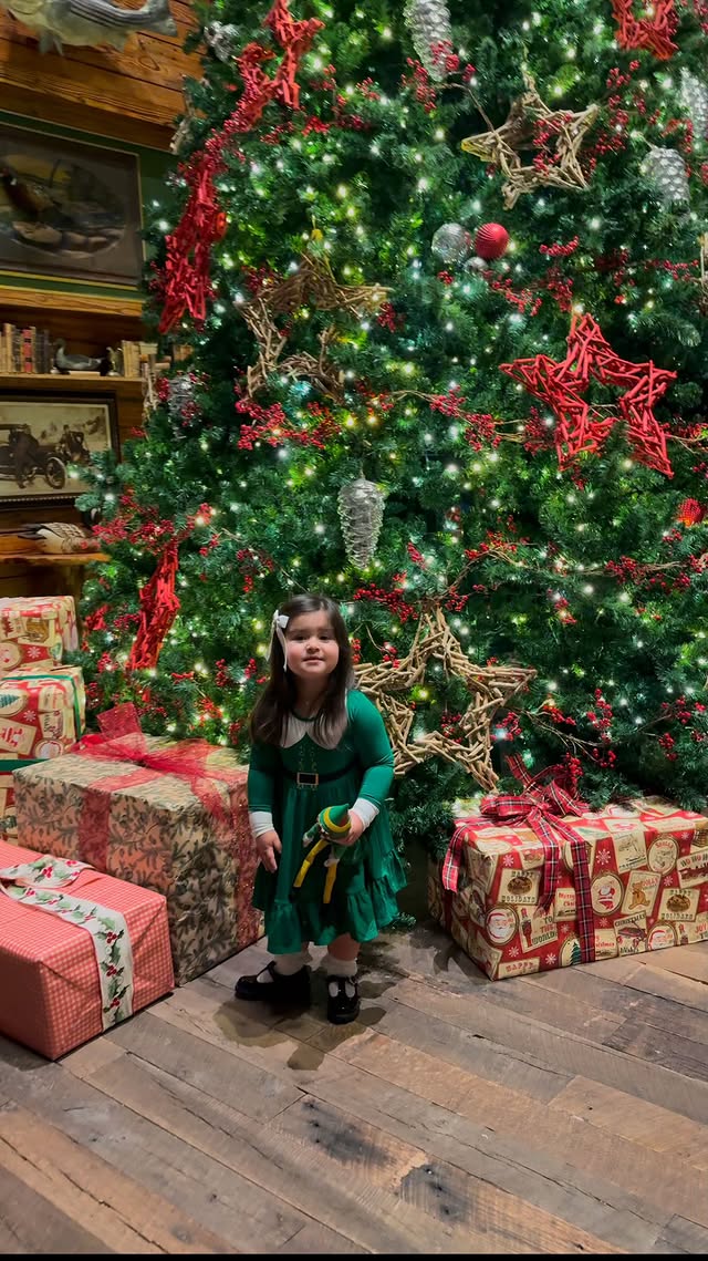 Instagram post by an influencer for Bums & Roses. Caption reads: Little elf takes buddy the elf to see Santa....