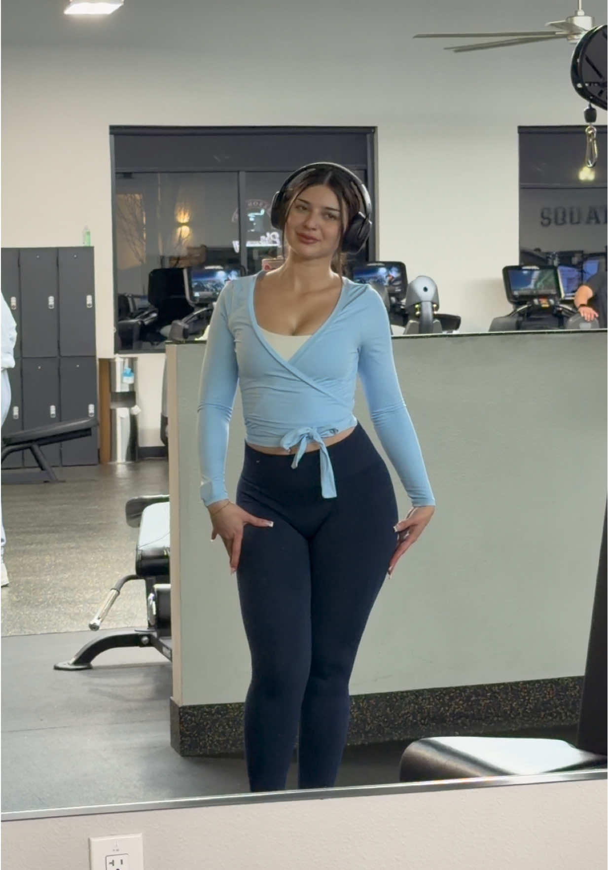 TikTok post by @teresabarajas_ for Yeoreo. Caption reads: size SMALL wrap top🐬🚙🔷🩵🫐  @YEOREO #gymgirl....