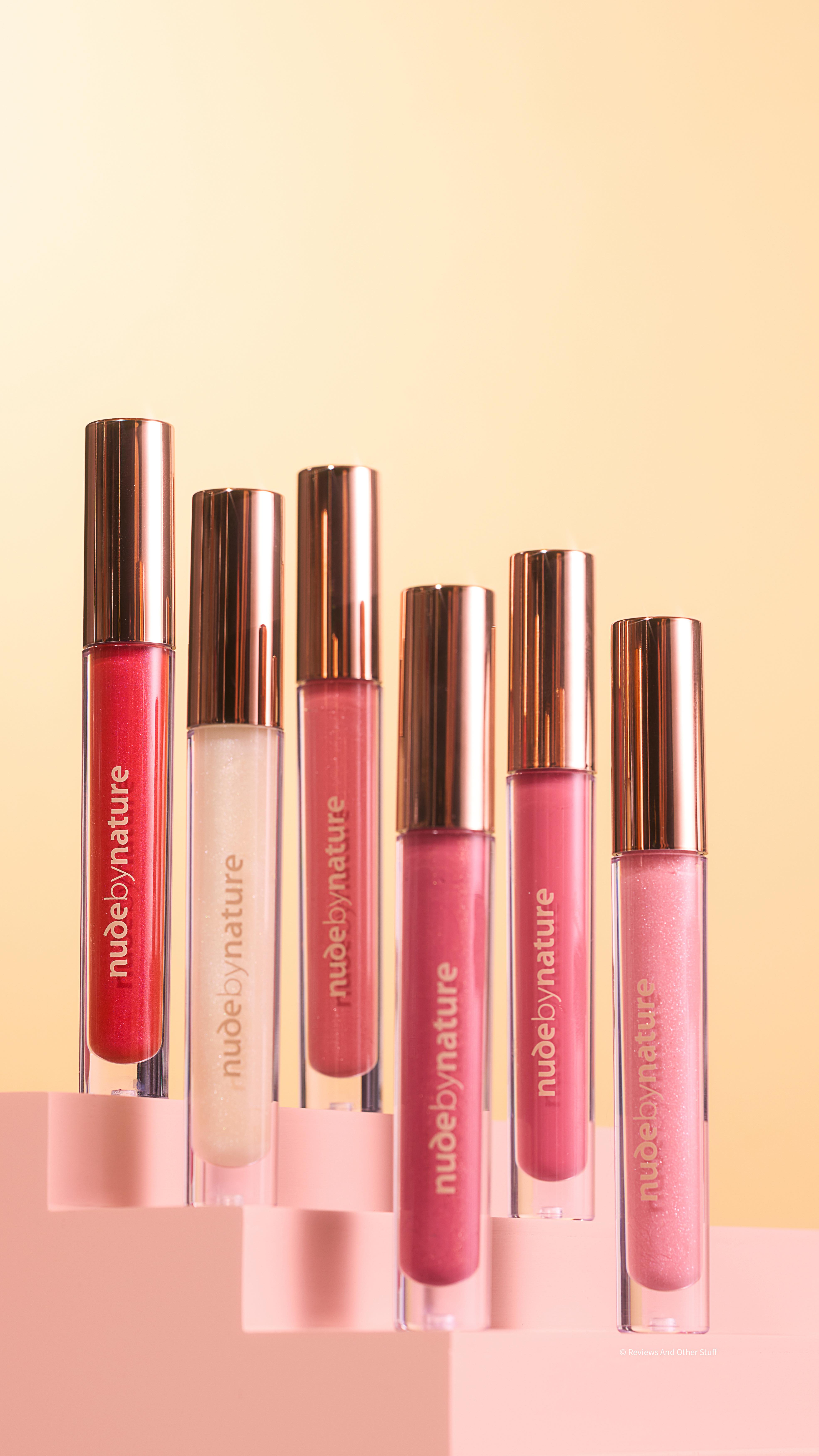 Instagram post by @reviewsandotherstuff for Nude by Nature. Caption reads: Meet the gloss that does more than shine —....