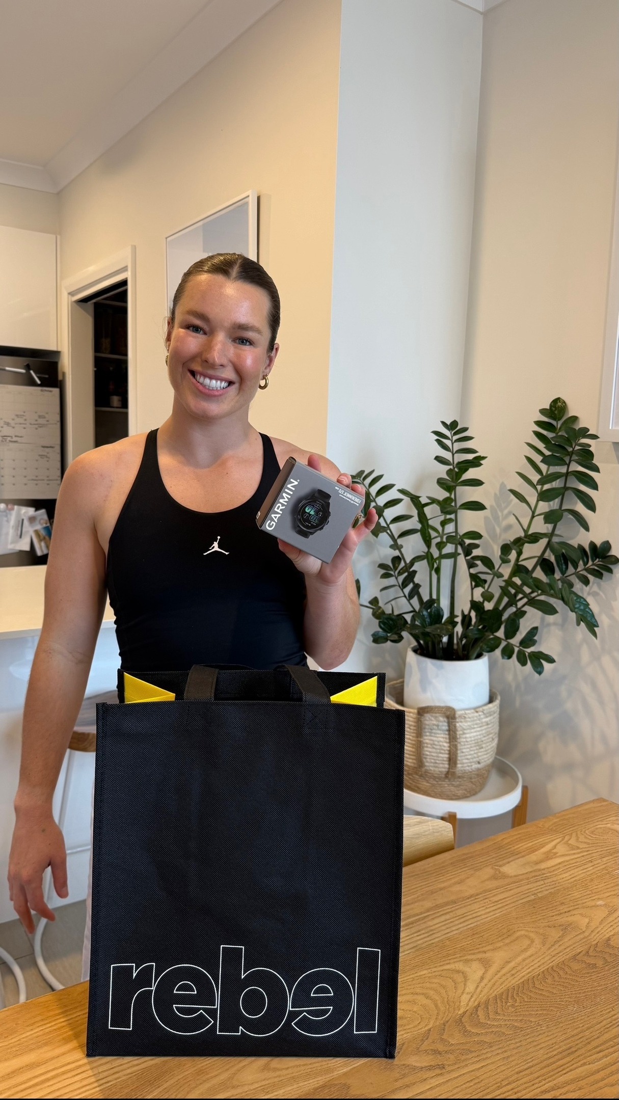 Instagram post by @emmatonegato for rebel sport. Caption reads: Unboxing the new Garmin Forerunner 570 with....