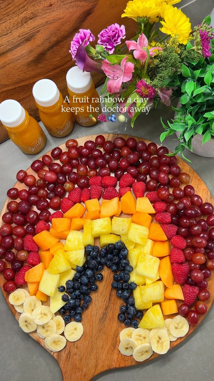 Instagram post by @nourishedbynour_ for The Squeezed Juice. Caption reads: Built this ✨rainbow fruit board✨ and it’s giving....