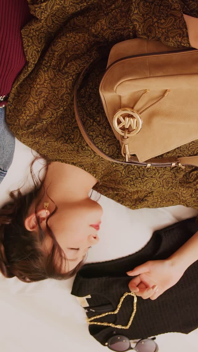 Instagram post by @yuna_3047 for Michael Kors. Caption reads: MY HOTEL STORIES
マイケル・コースのアイコニックなハンドバッグ “NOLITA”....