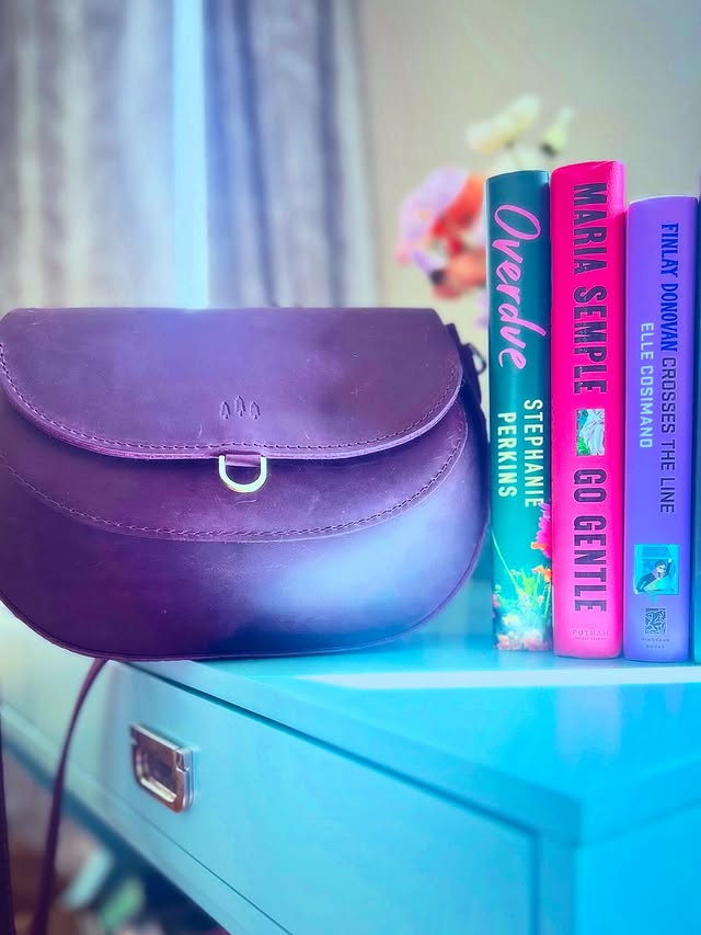 Instagram post by @meghan_readsbooks for Portland Leather Goods. Caption reads: My weekend is, as we say, booked. Looking for a....