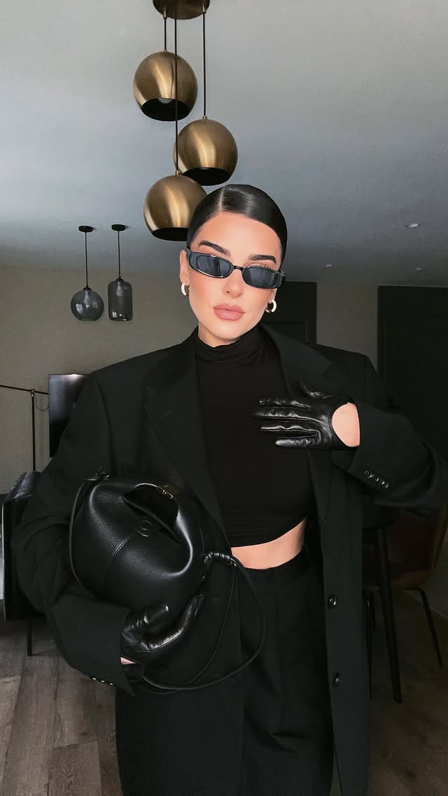 Instagram post by an influencer for Erdluxe. Caption reads: edgy elegance 🖤 Anzeige Suit @erdluxe Bag....