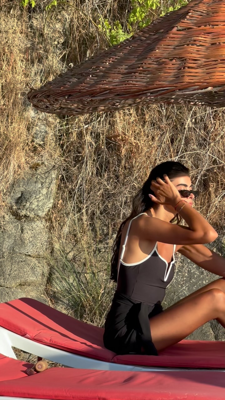 Instagram post by @selennergiz for Oysho. Caption reads: Just me, the sun, and my black suit 🖤 #fyp #ootd....