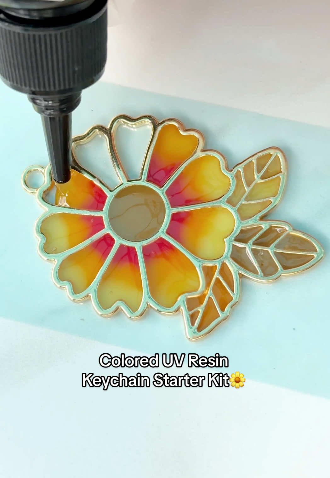 TikTok post by @thejewelrybabe for Let’s Resin. Caption reads: Made a fall flower keychain from the @LET'S RESIN....