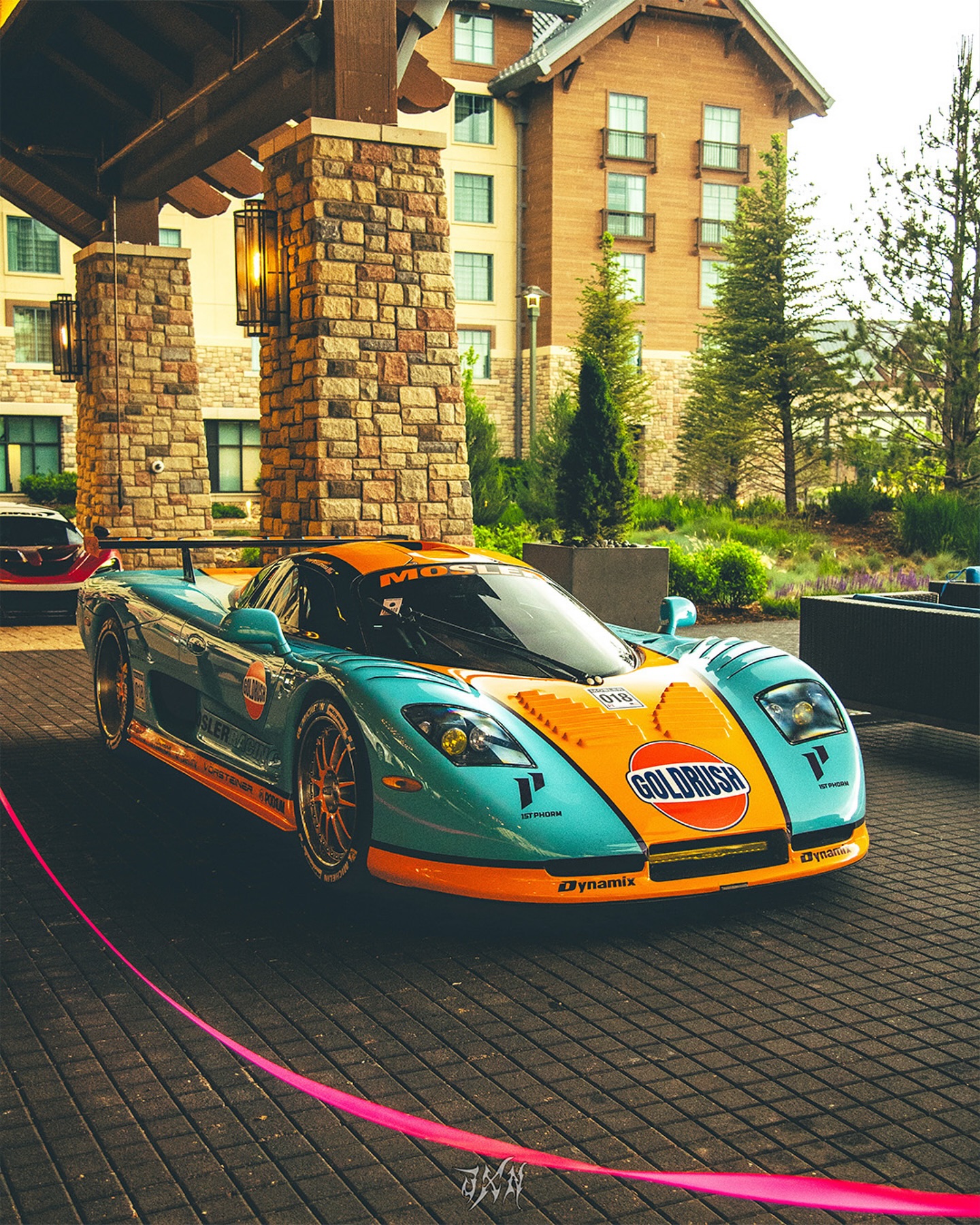 Instagram post by @aci_dynamix for 1st Phorm. Caption reads: The Mosler MT900 is a high-performance sports car....