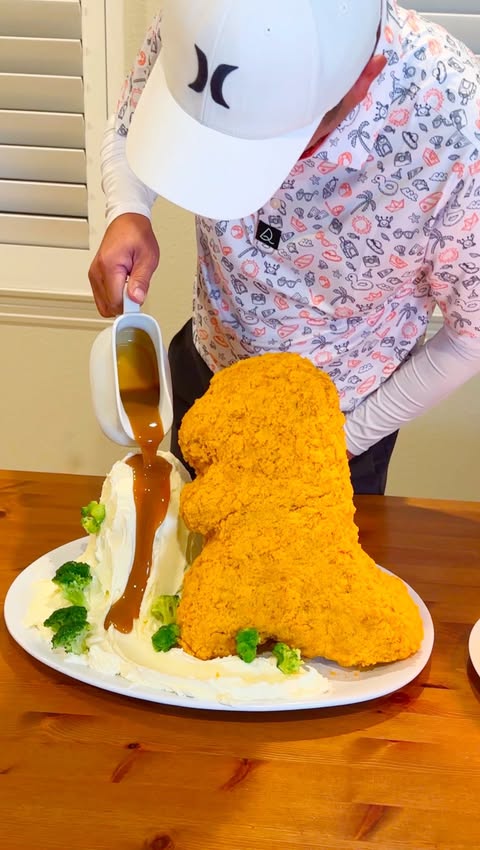 Instagram post by @cocobellycakes for Jurassic World. Caption reads: A Giant Dino Nugget for my husband. @jurassicworld....