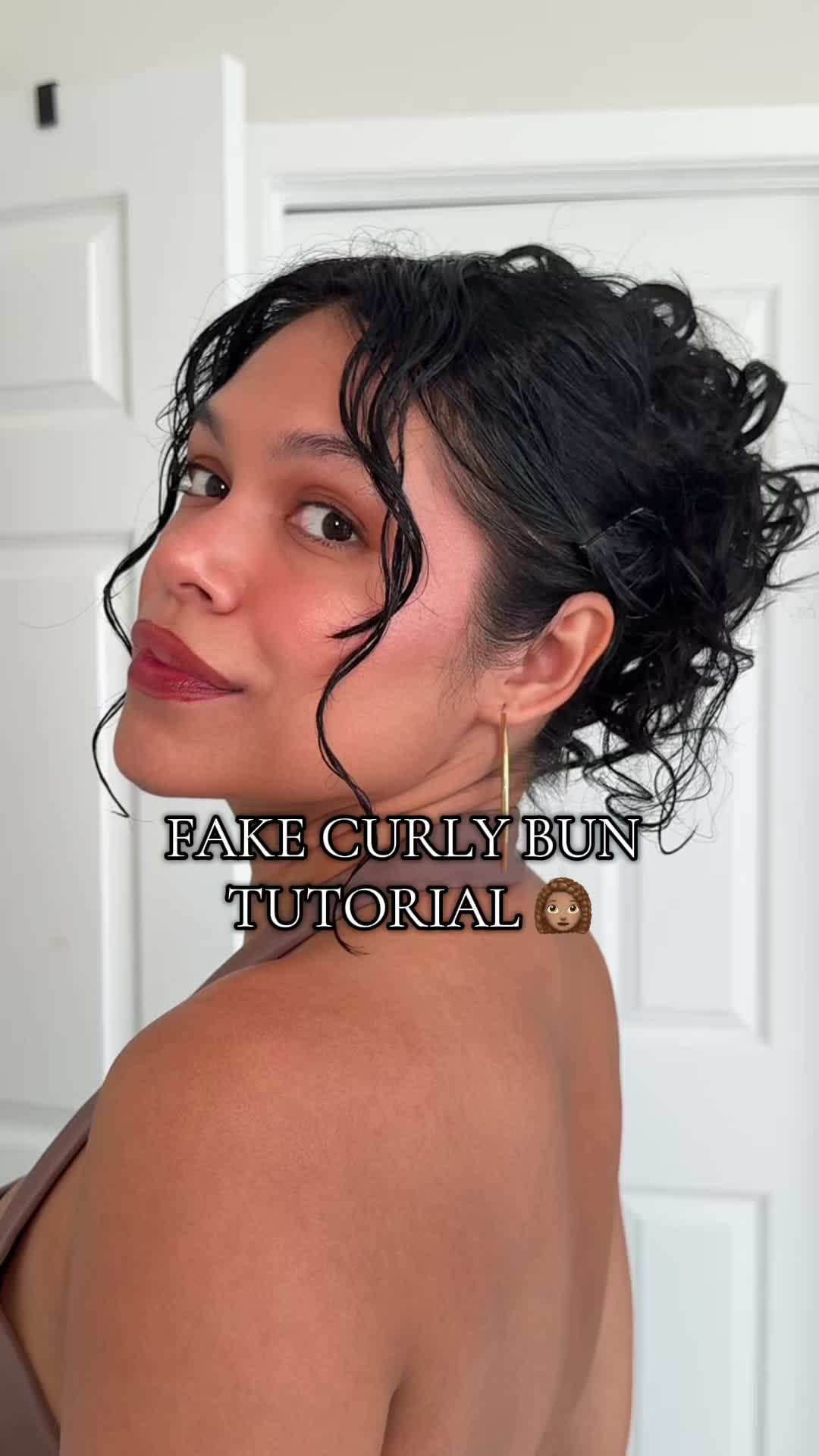 TikTok post by @les.ohh for Insert Name Here. Caption reads: Obsessed with my @INH HAIR cami curly hair bun....
