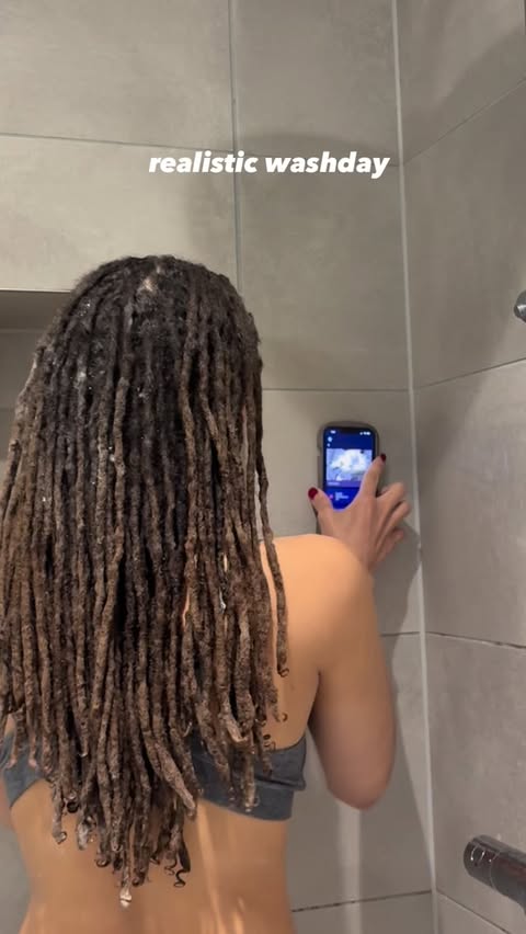 Instagram post by @bryslocs for Owlet. Caption reads: [...] the shower wall (app & monitor gifted by....
