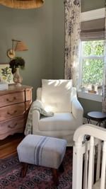 Instagram post by @kynoelle for Namesake Home. Caption reads: The coziest corner in our new baby Lila’s nursery....