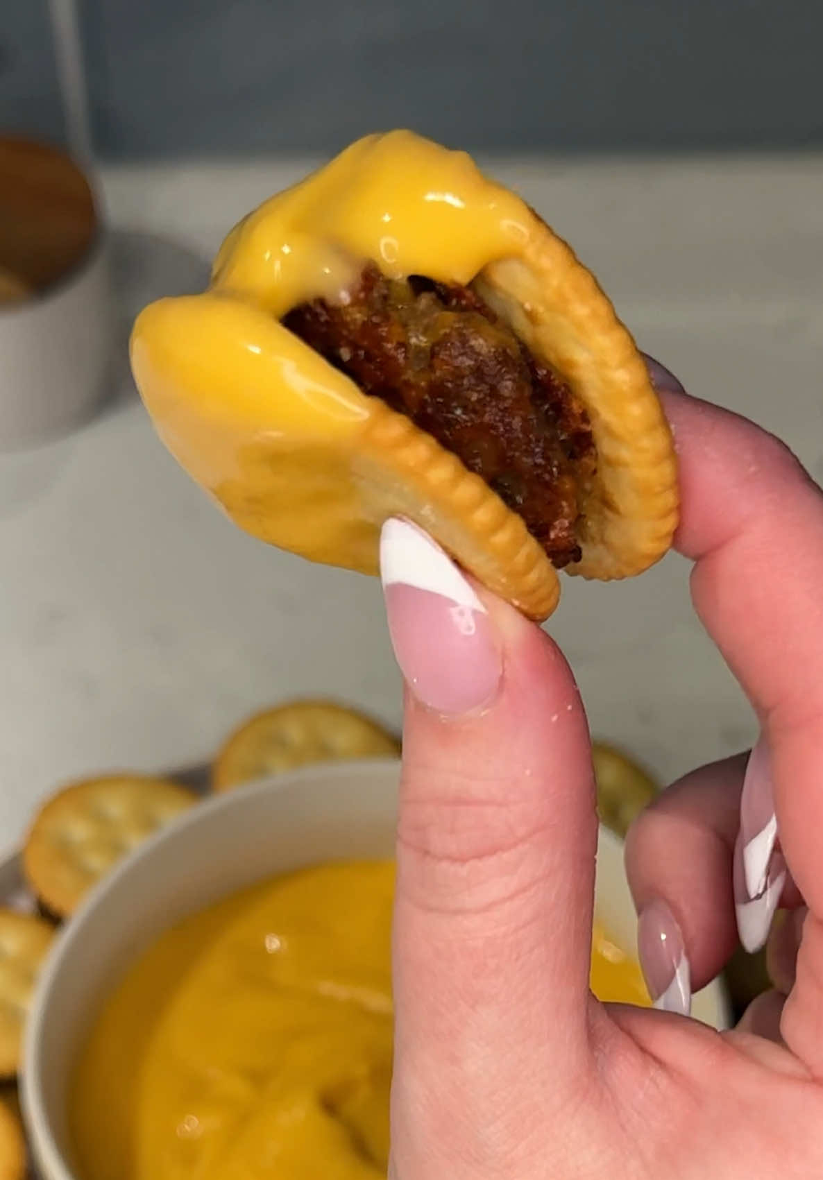 TikTok post by @ashleymarkleeats for RITZ Crackers. Caption reads: you HAVE to try these cheesy mini cracker....
