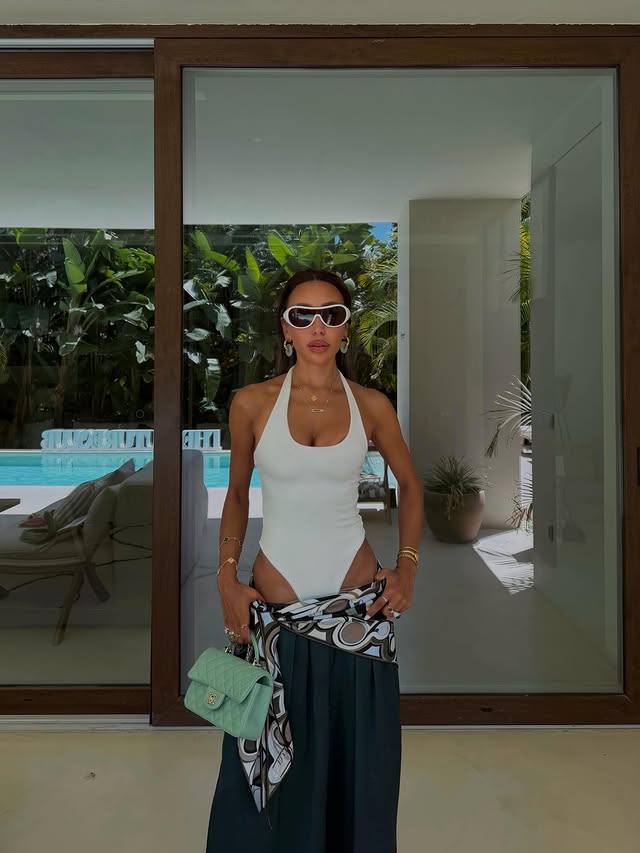 Instagram post by @aimazin for The Couture Club. Caption reads: Checked into @thecoutureclub 🌴🪇ad.