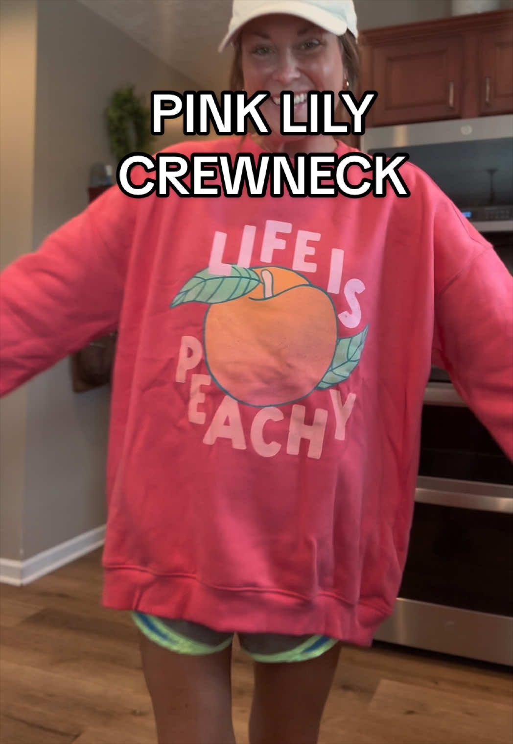 TikTok post by an influencer for Pink Lily. Caption reads: @The Pink Lily 🍑🍑🍑 #pinklily #crewneck [...].