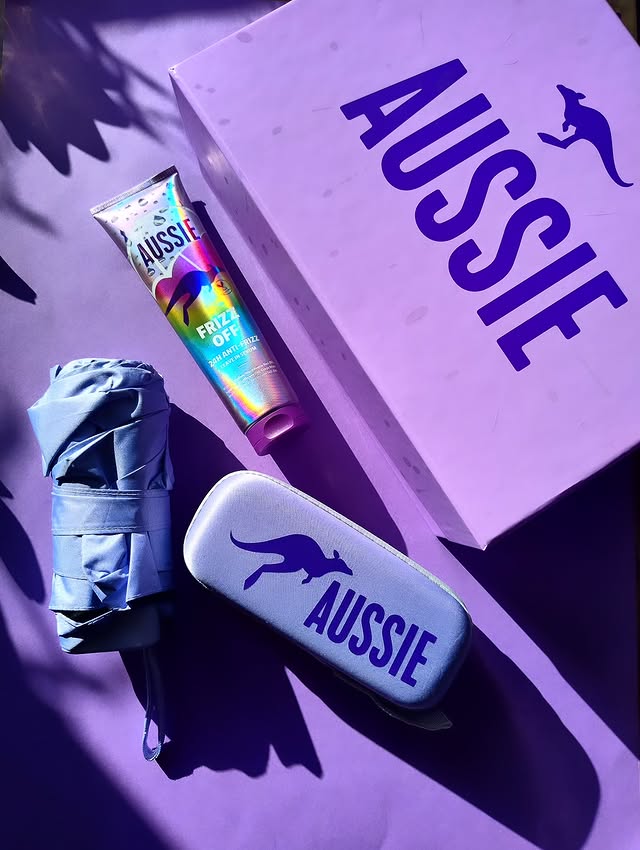 Instagram post by @malgorzata.wojas for Aussie Haircare. Caption reads: Rain? Humidity? Frizz? I’m saying FRIZZ OFF! ☔✨....