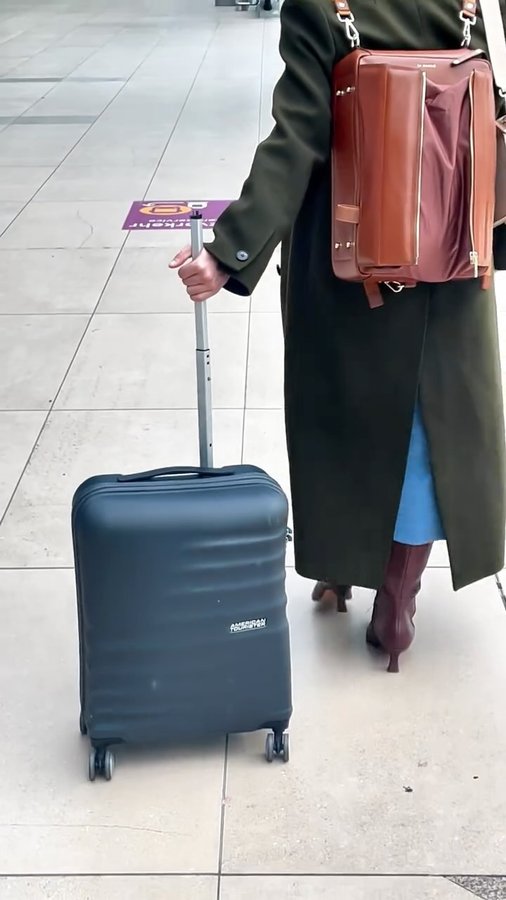 Instagram post by @aynur.science for American Tourister. Caption reads: We arrived safe and sound in Germany, but our....