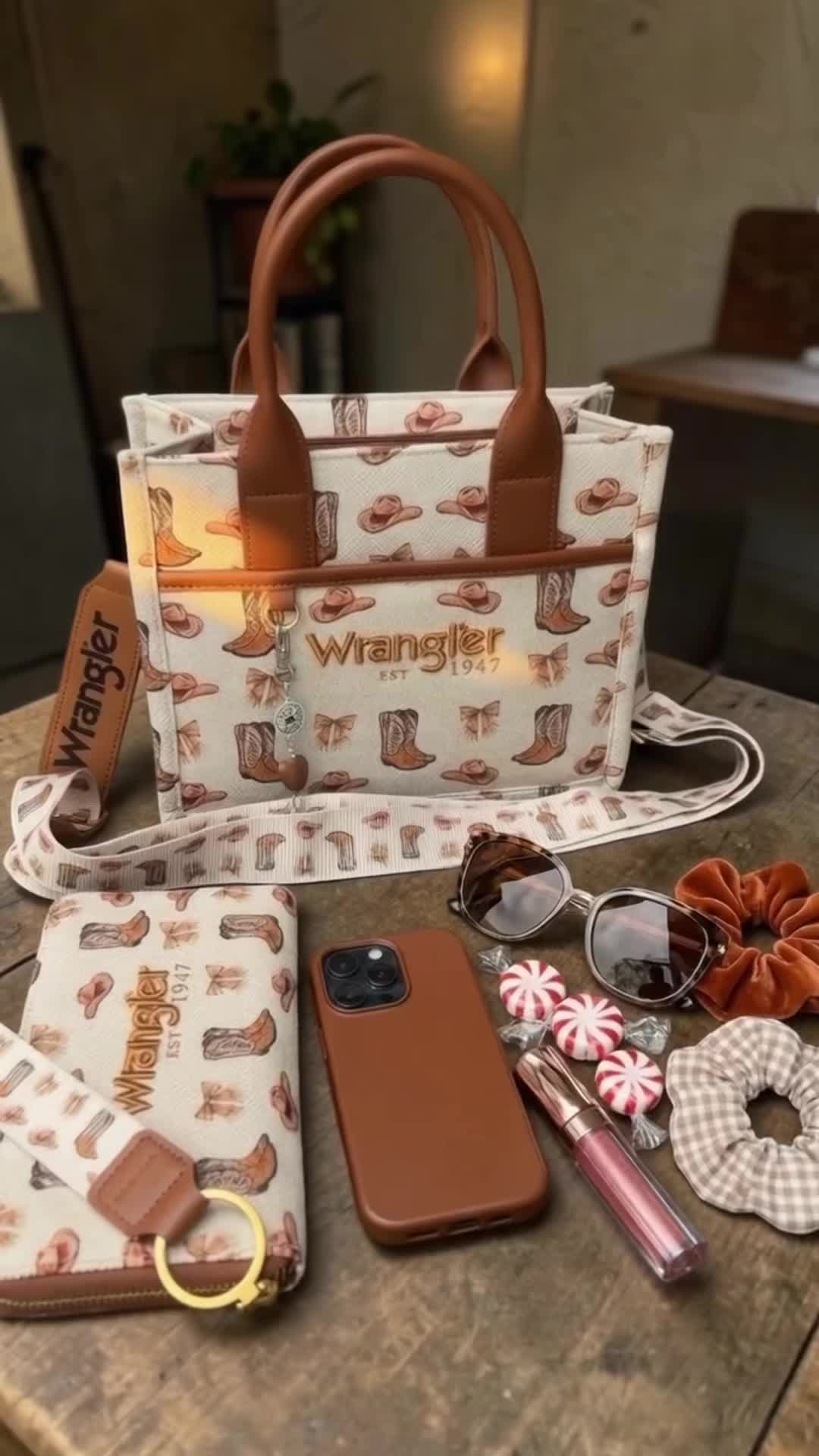 TikTok post by @justagirlfinds for Vaqueras Outfitters. Caption reads: 🤎👢 @Vaqueras Outfitters • #wrangler #totebag....