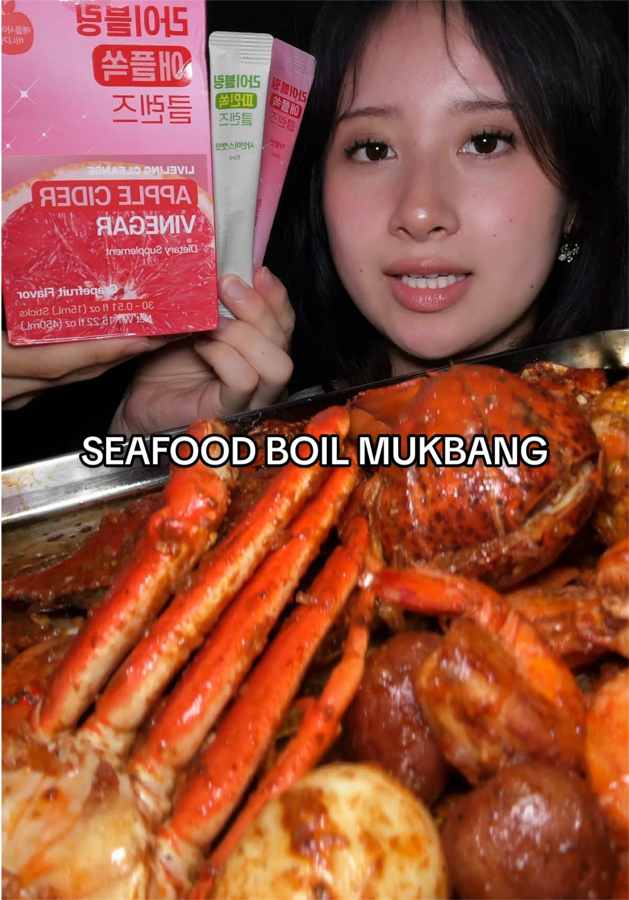 TikTok post by @selenaeats2much for Fullight_global. Caption reads: seafood boil with my go-to vinegar drink @Fullight....