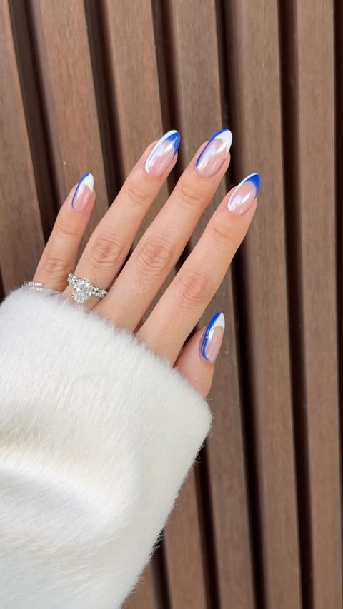 Instagram post by @nailsbyzola for OPI. Caption reads: [...] this beauty 🤍💙 Products I used: @opi....
