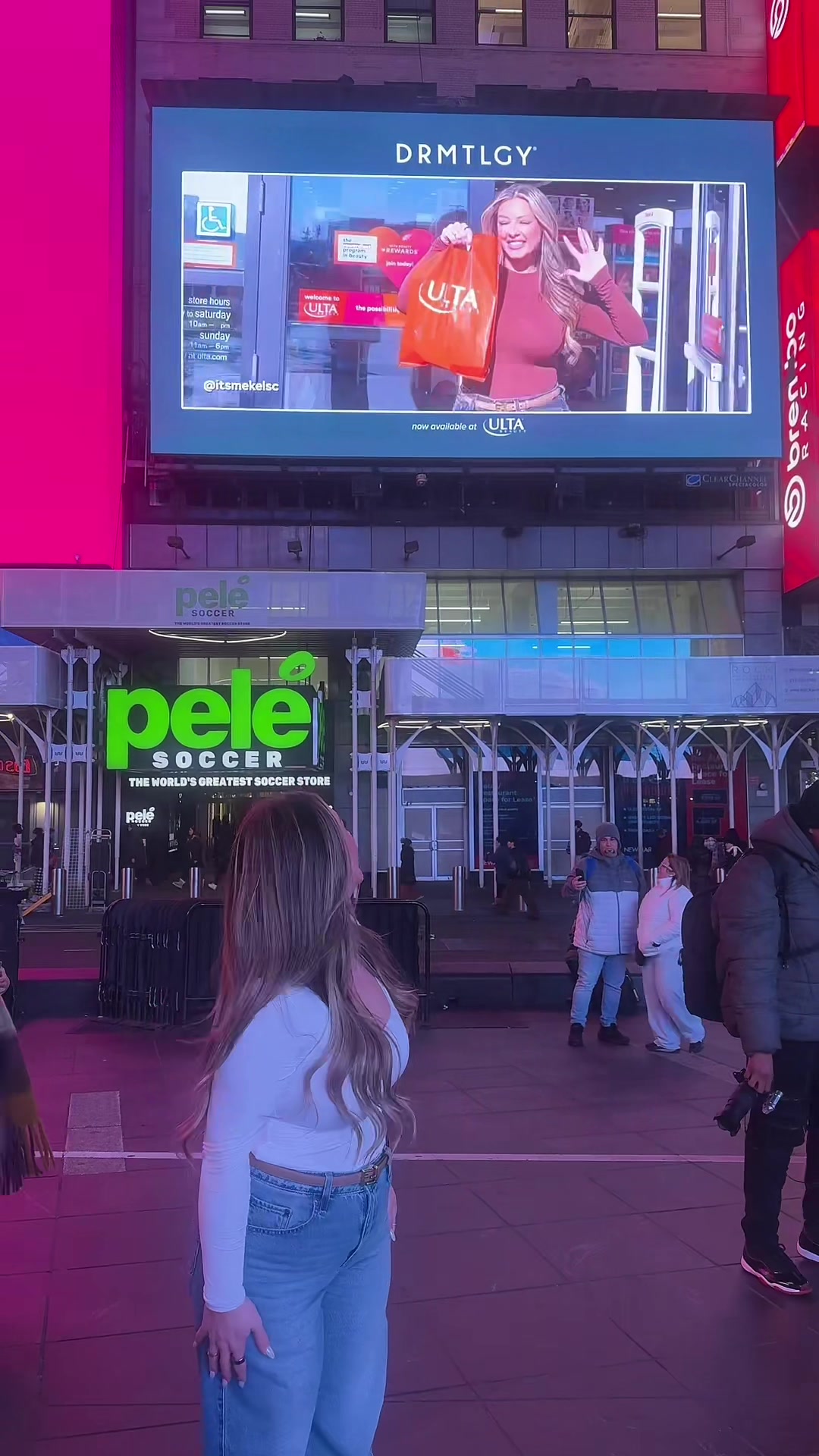 TikTok post by @itsmekelsc for DRMTLGY. Caption reads: IM ON A BILLBOARD IN TIMES SQUARE WITH @DRMTLGY....