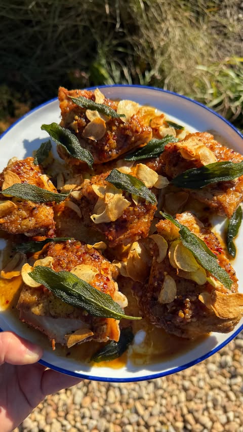 Instagram post by @haileecatalano for Made In Cookware. Caption reads: crispy chicken thighs with fried garlic, sage and....