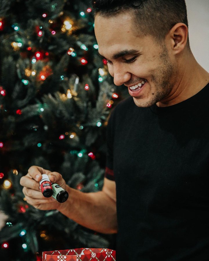 Instagram post by @therealcarlospena for Young Living. Caption reads: I love the holidays and I LOVE to give! But I have....