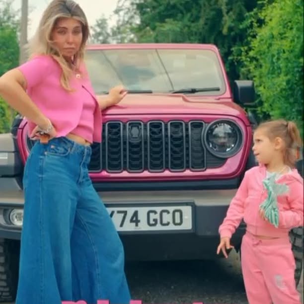Instagram post by @cara_delahoyde for Jeep. Caption reads: Celebrate National Pink Day in style – the Jeep....
