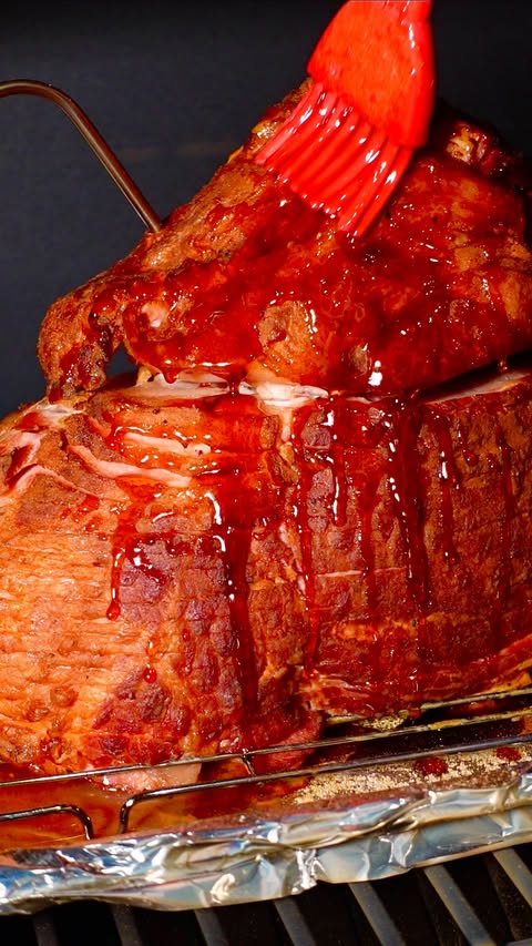 Instagram post by @girlgonegrilling for Pit Boss Grills. Caption reads: [...] Smoked spiral sliced ham on the....