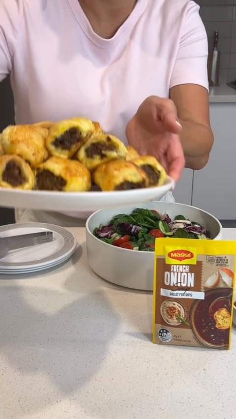Instagram post by @dezi_cooks for MAGGI Belgium. Caption reads: Upgrade your sausage rolls with this easy hack.....