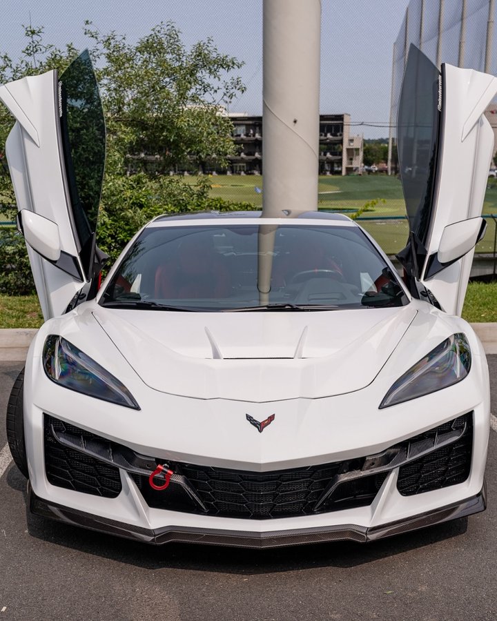 Instagram post by @kustom_interior for Vertical Doors Inc. Caption reads: My C8 Z06 now has vertical doors!!! 😍😍😍🔥🔥🔥 I....