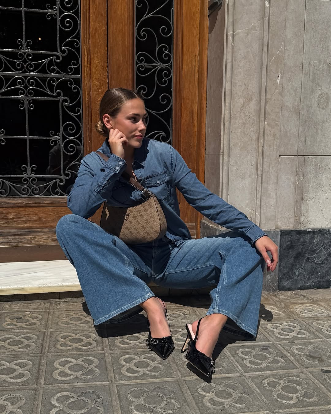 Instagram post by @claraaafernandez for GUESS. Caption reads: Ad* Day off in Barcelona wearing @guess . Just....