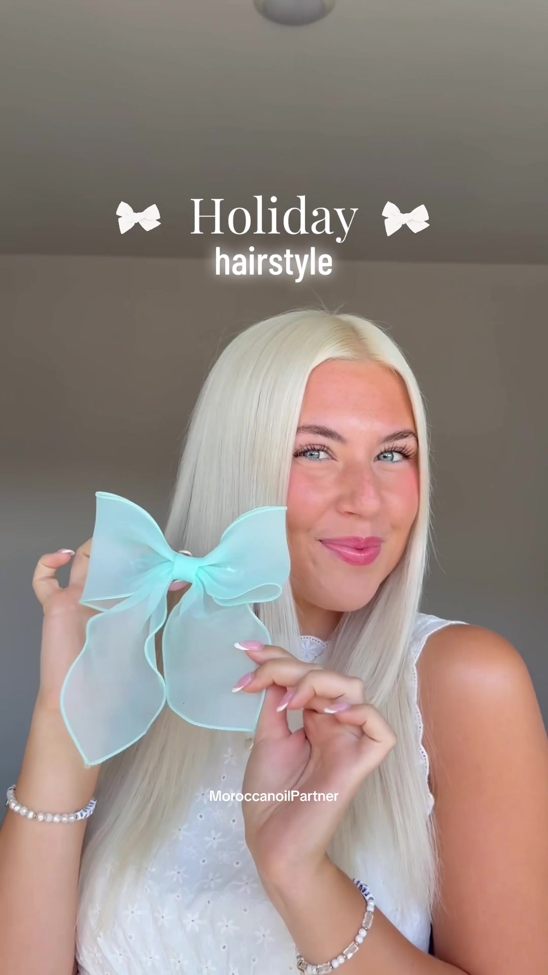 TikTok post by @taylor_pfeffer for Moroccanoil. Caption reads: The cutest holiday hairstyle using all....