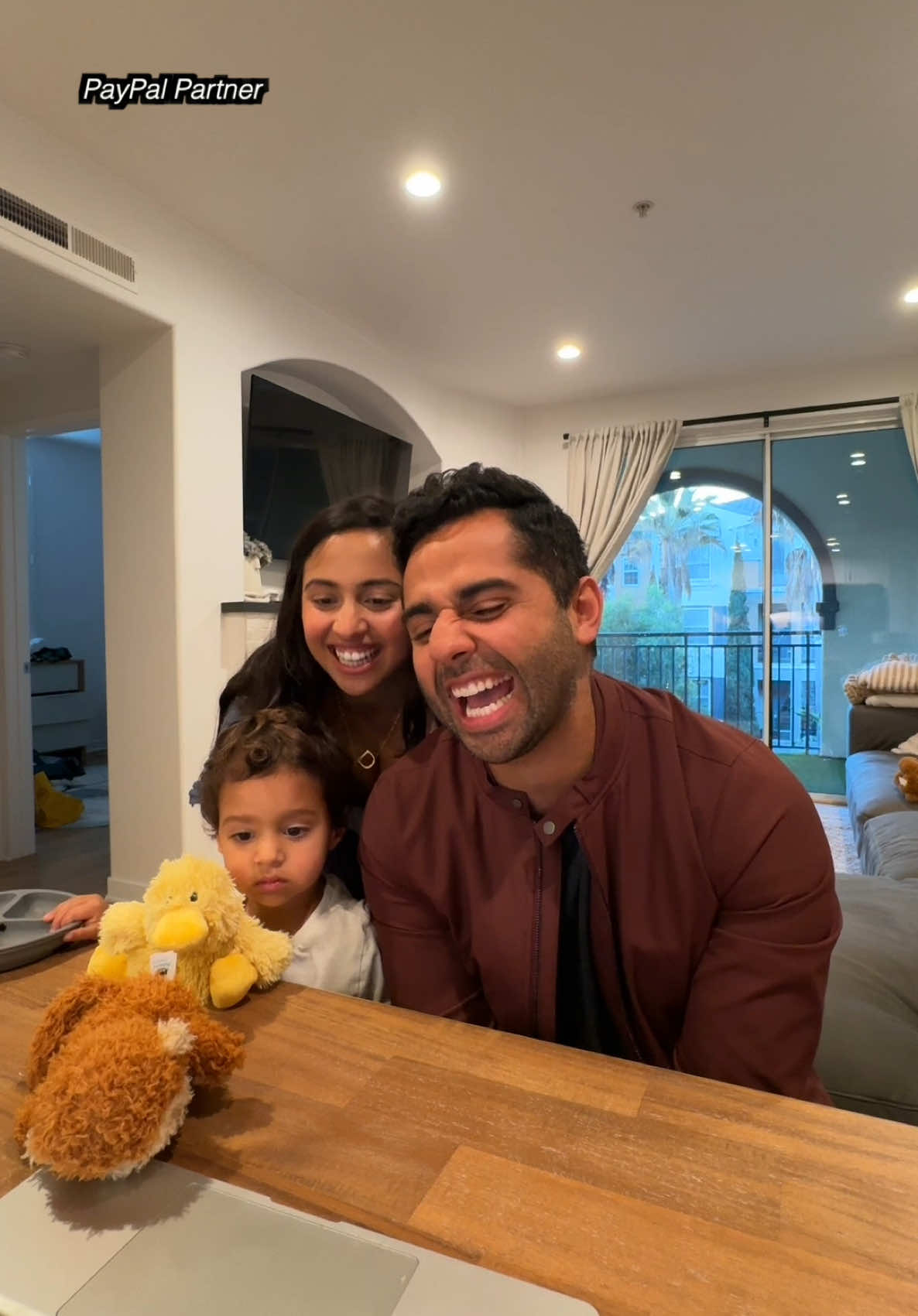 TikTok post by @rezaandpuja for PayPal. Caption reads: You deserve the world, Mom & Bobby ❤️ Partnered....