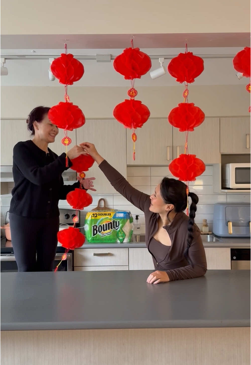 TikTok post by @camleeyoga for Bounty. Caption reads: Welcoming Lunar New Year with Mom & @Bounty Paper....