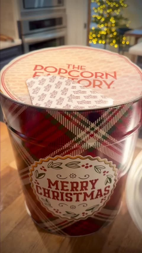 Instagram post by @tinytimetraveler for The Popcorn Factory. Caption reads: #Ad Popcorn is an essential part of our movie....