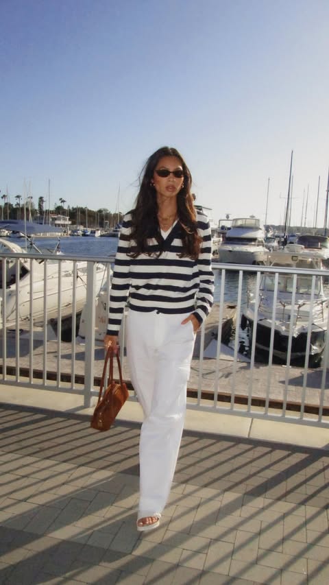 Instagram post by @amandapandapaige for Nautica. Caption reads: Just a gal who loves stripes @nautica ⚓️ #partner.