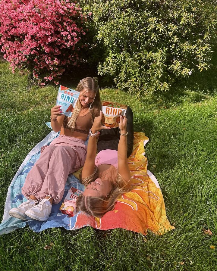 Instagram post by @emilysentnerr for RIND Snacks. Caption reads: the perfect picnic day with....