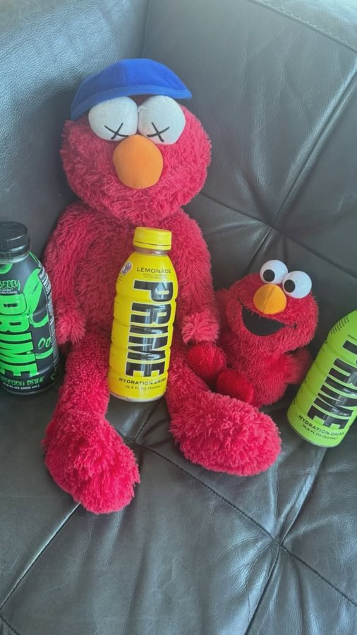 Instagram post by @kosherelmo for Sesame Street. Caption reads: [...] #energy #promo #ad #kosherelmo #kaws....