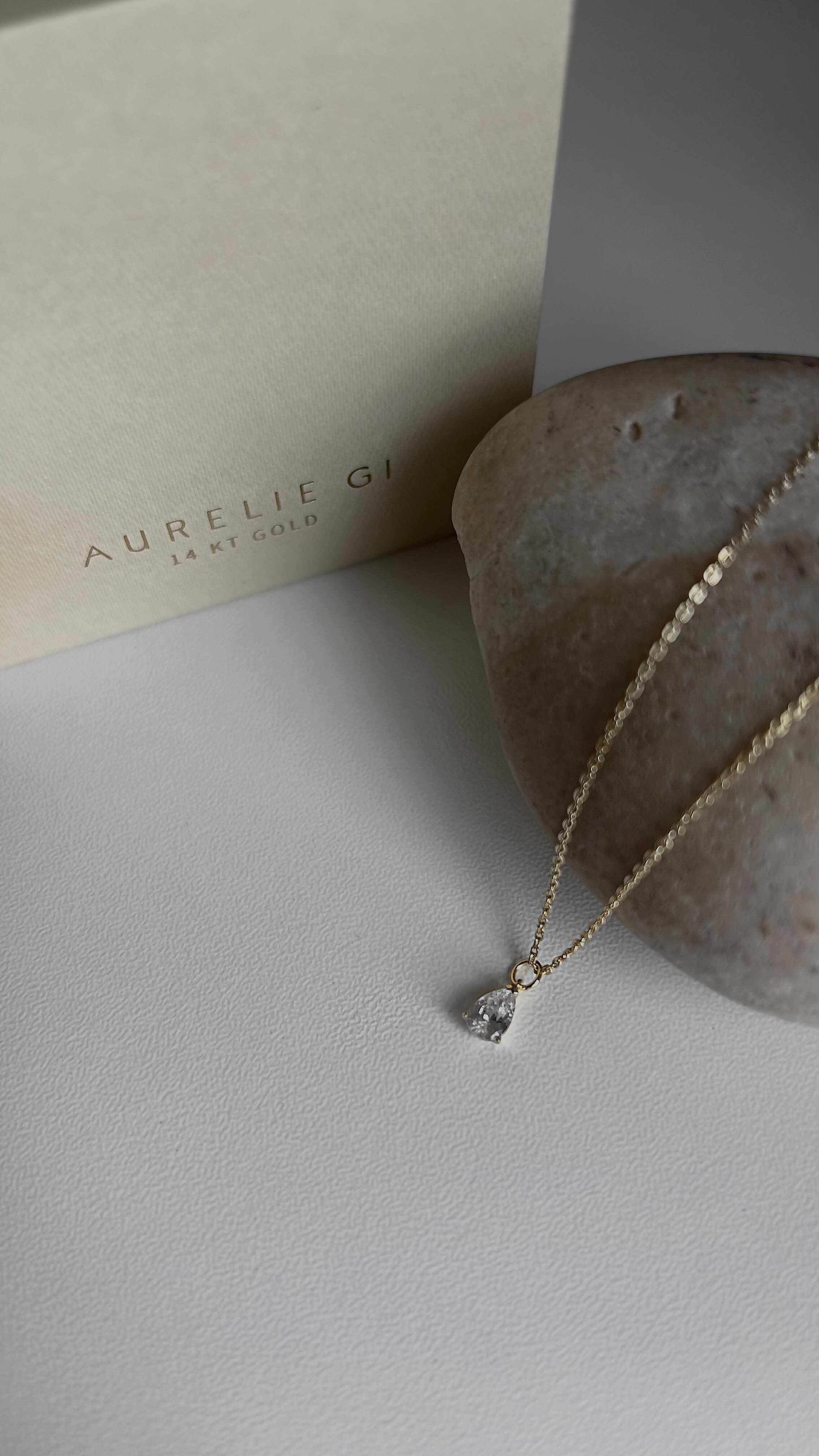 Instagram post by @melinaxzay for Aurelie Gi. Caption reads: 💗 Partnering with @aureliegijewelry She’s....