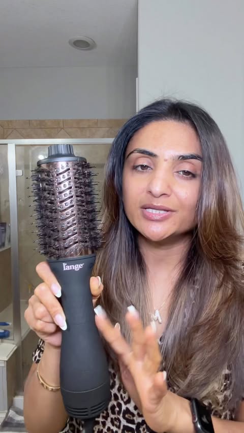 Instagram post by @esthetician_munira for L’ange Hair. Caption reads: [...] Blowout Hair Dryer Brush @langehair....