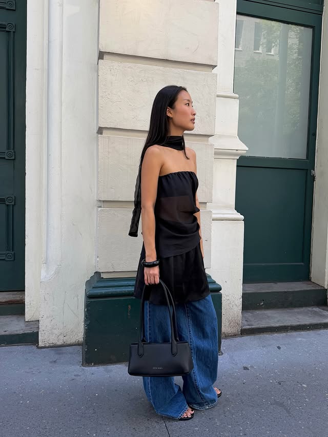 Instagram post by @_nickihan for Status Anxiety. Caption reads: Out and about with @status_anxiety 🖤 ad.