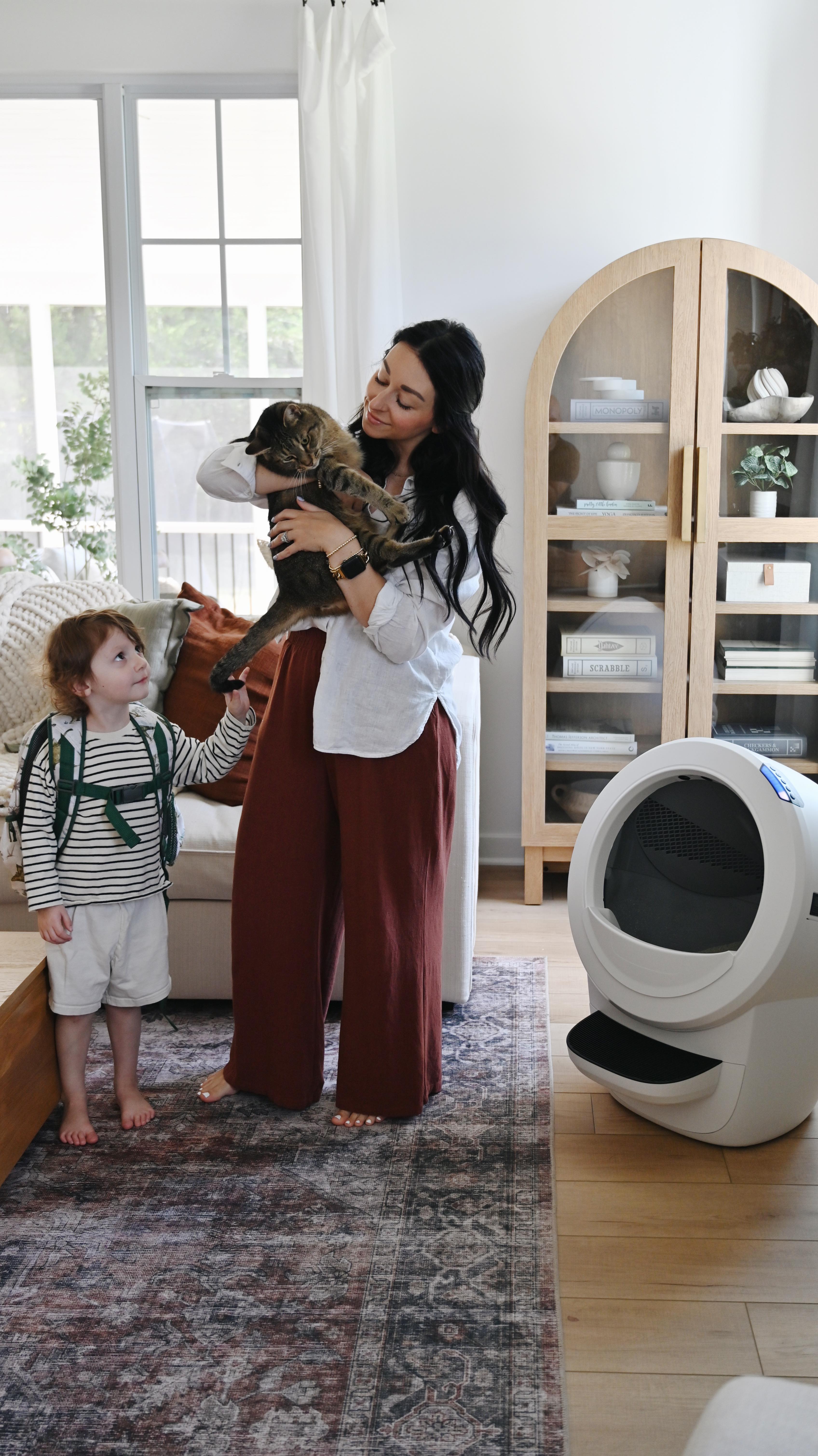 Instagram post by @emilywondree for Litter-Robot. Caption reads: Back to school season with 4 kids and 2 cats is....