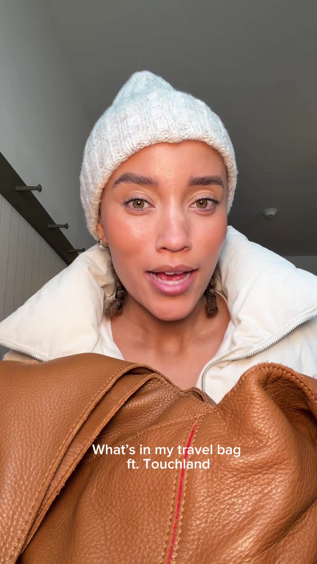 TikTok post by @officialellesmith for Touchland. Caption reads: What’s in my bag? @touchland  #touchlandpartner .